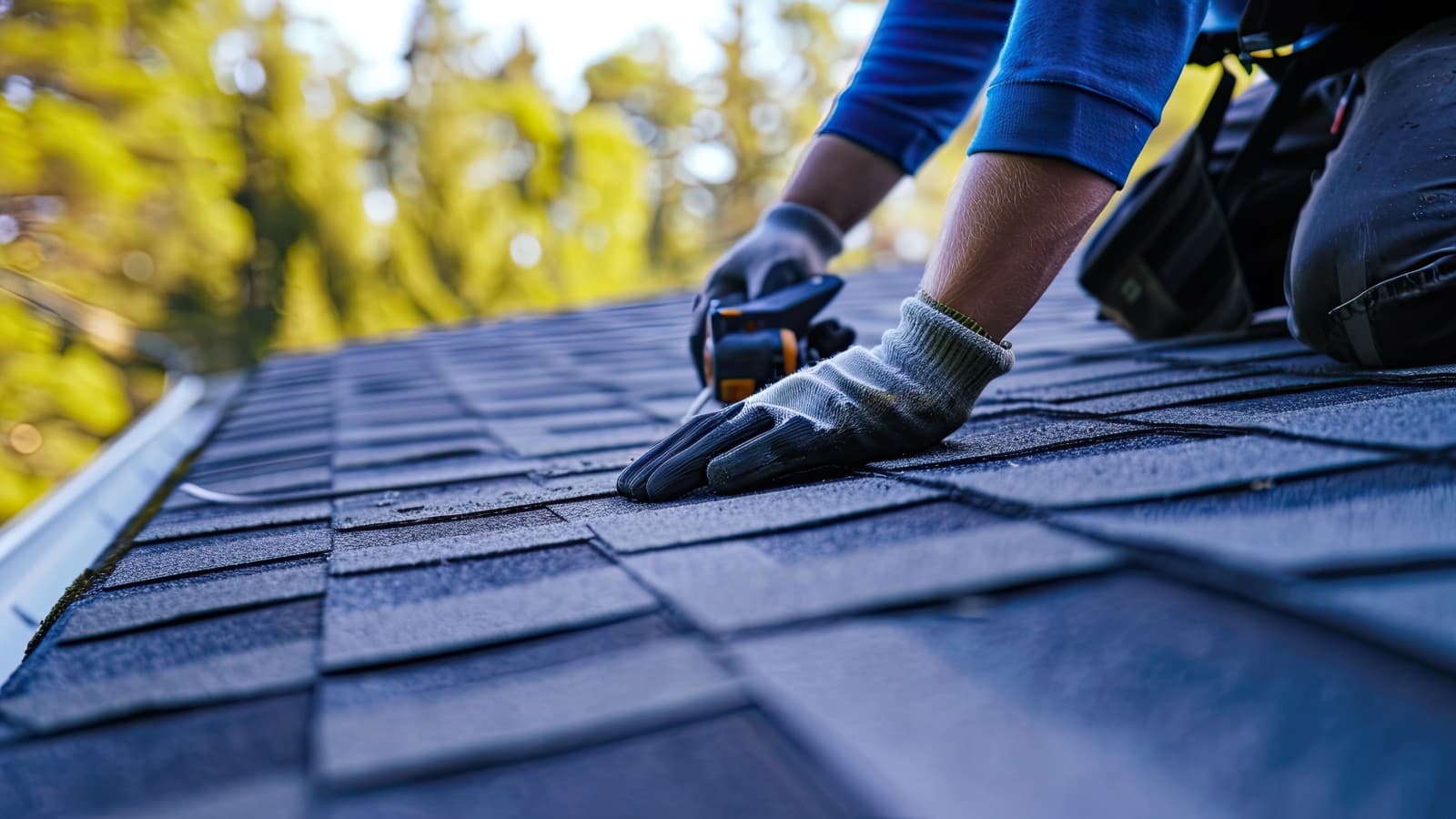 roofer working on a residential roof with tiles