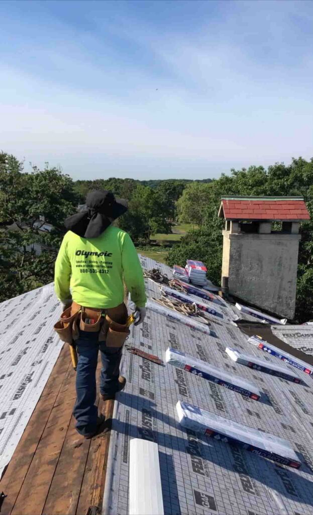 olympic roofer wearing branded shirt